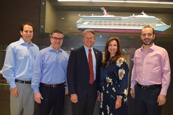 Carnival Cruise Line executives posing for port canaveral news about cruise terminal